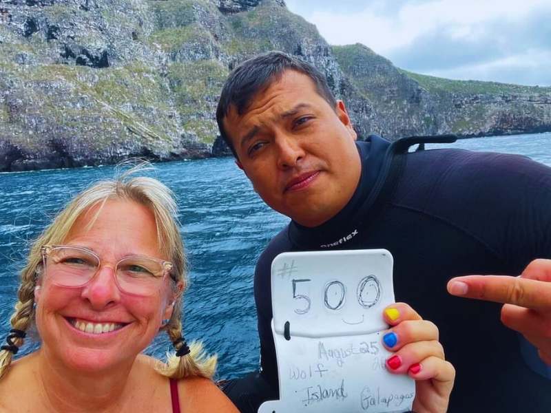 Wild George with a guest celebrating 500 dives milestone at Wolf Island in Galápagos.